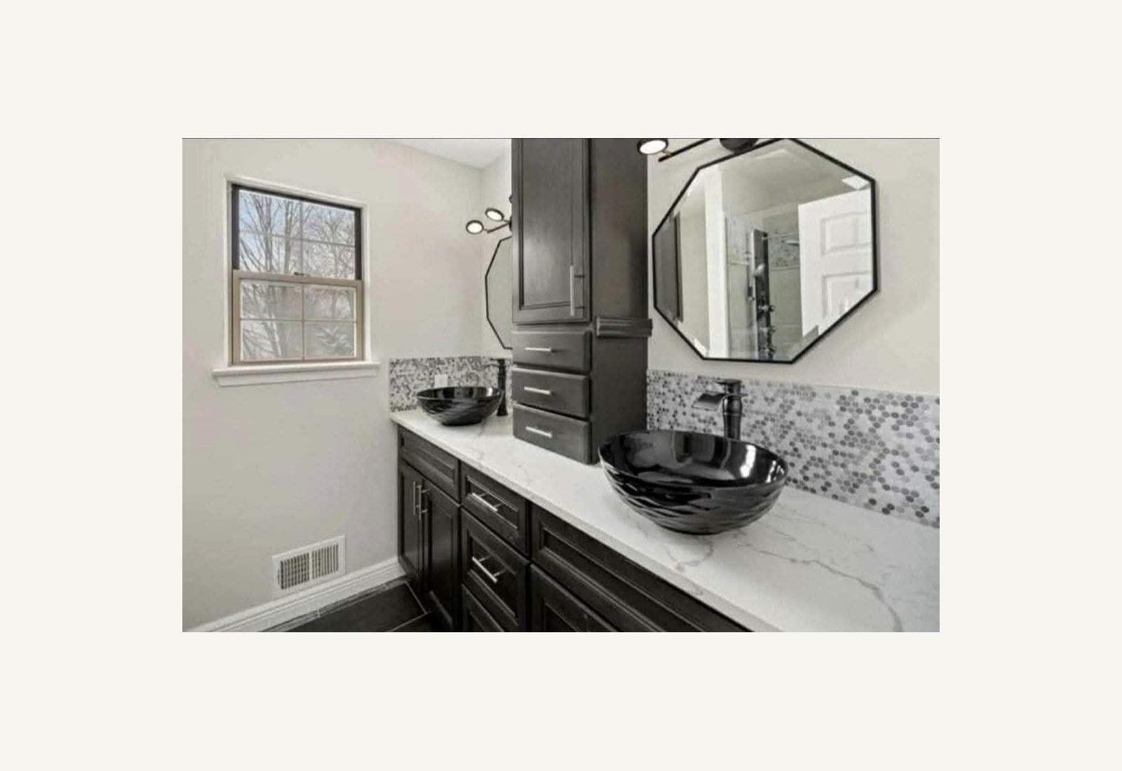Reliable Renovators bathroom after photo with black double vanity and updated tile in Metro Detroit