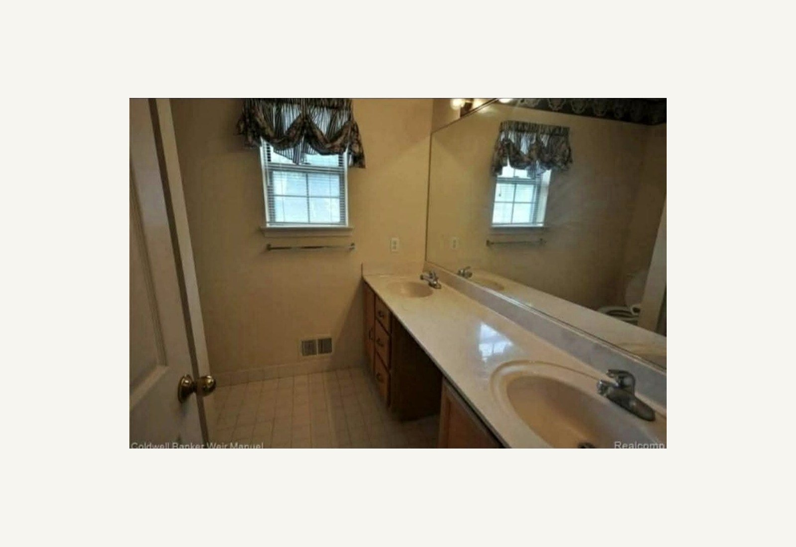 Reliable Renovators bathroom before photo with yellow double vanity in Metro Detroit