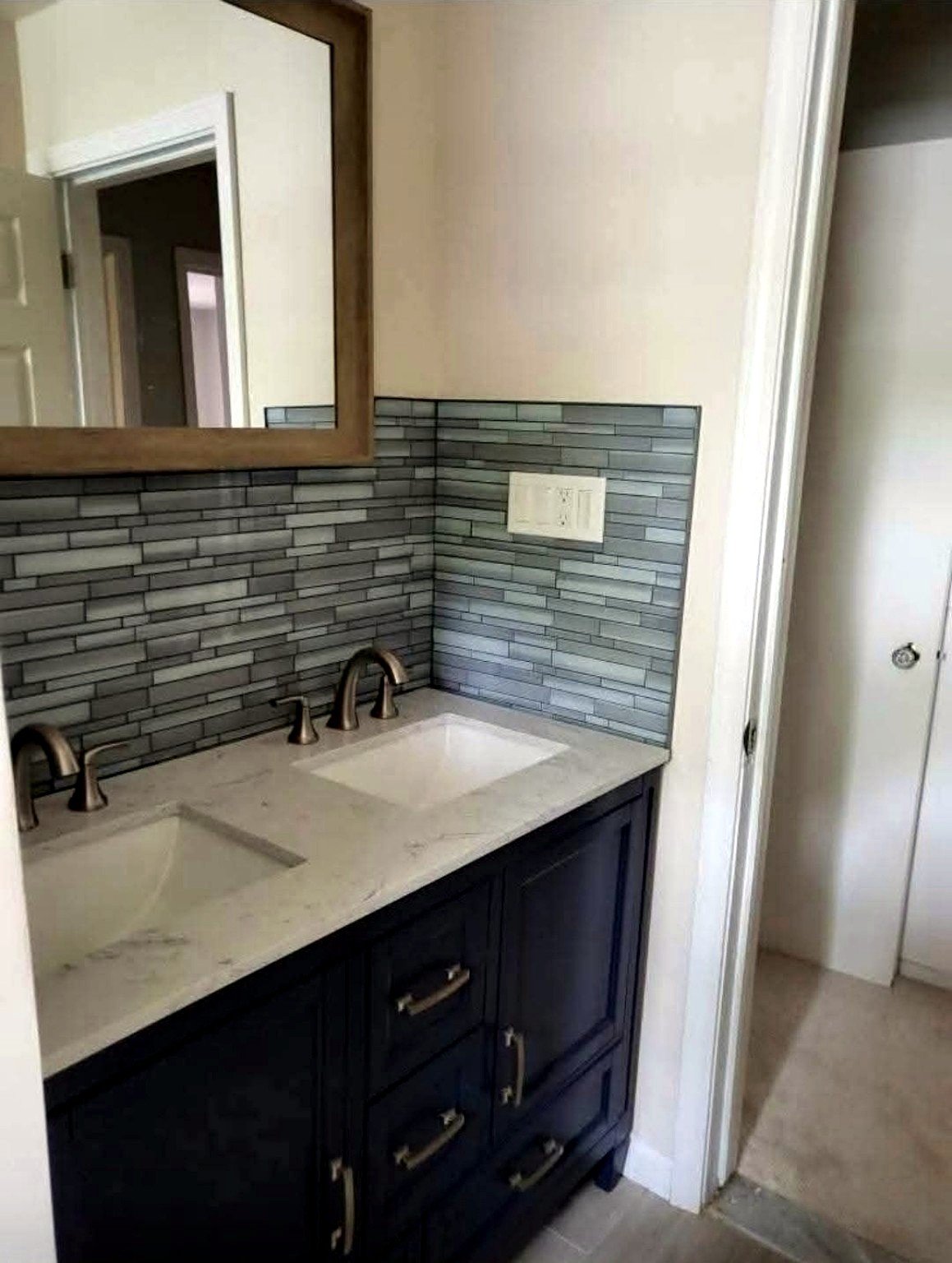Reliable Renovators bathroom remodel detail with double vanity tile and finished bathroom in Metro Detroit
