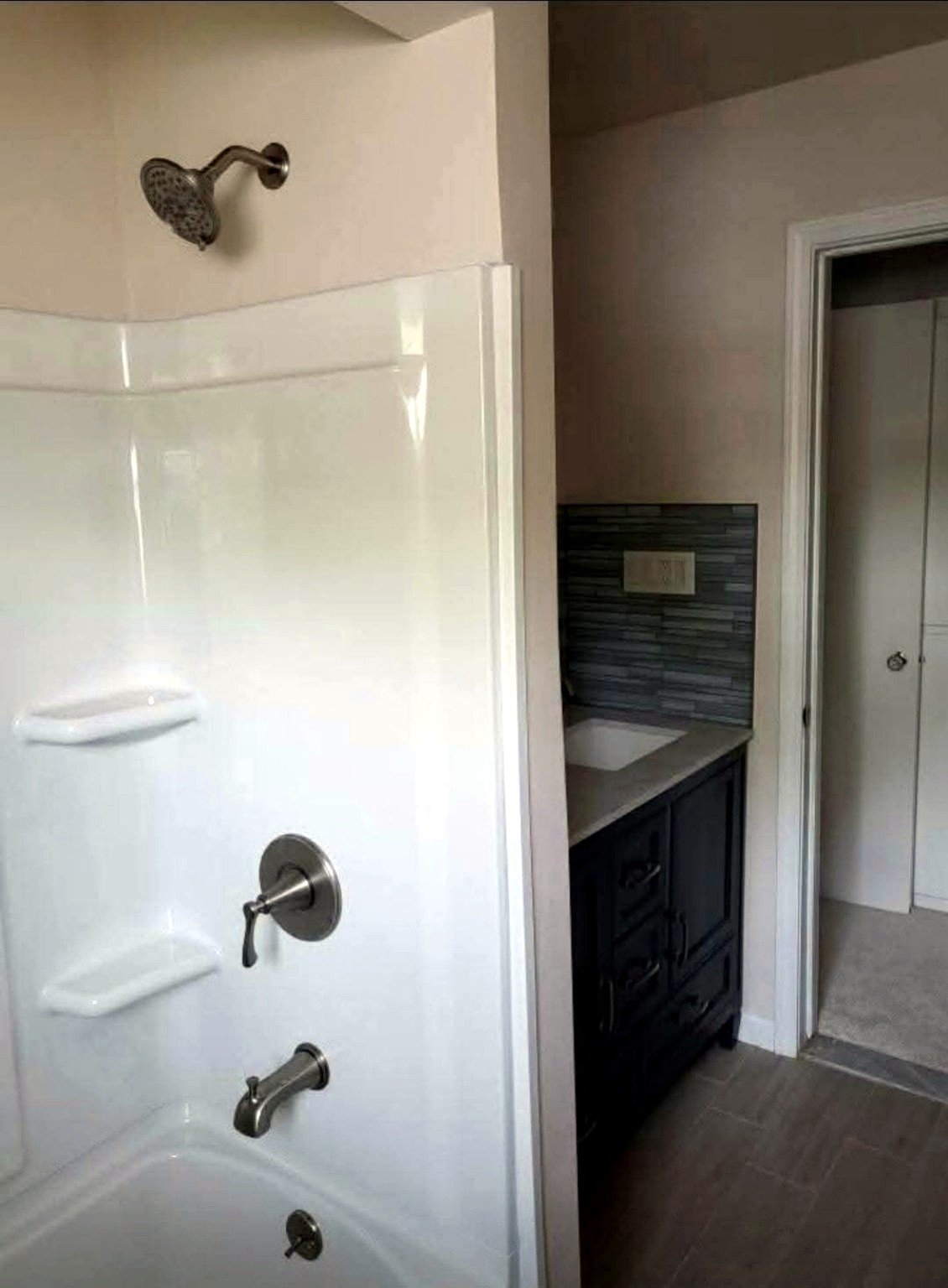 Reliable Renovators bathroom remodeling after with shower vanity and tile in Metro Detroit